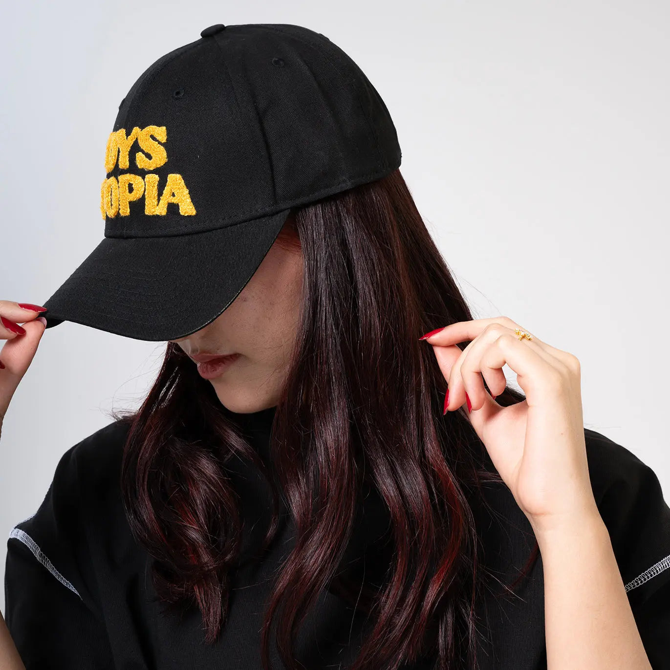 Black Cap with Yellow Logo the in. concept